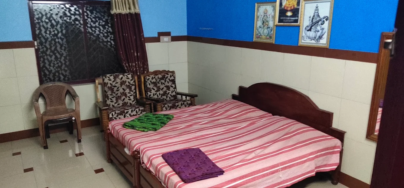 Bedroom with blue wall and seating